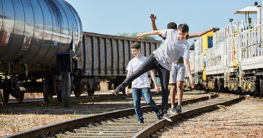 Group of young boys playing on the tracks